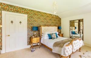 a bedroom with a bed and a mirror at Unique Manor House PLUS Jacuzzi PLUS BBQ Cabin in Maybole