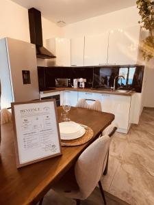 a kitchen with a wooden table with a plate on it at Le T3 Élégance Lyon aéroport in Janneyrias