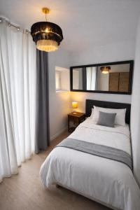 a bedroom with a bed and a large window at 31CaL QuEROL Boutique centre Puigcerdà in Puigcerdà +6 photos