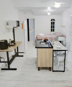 a kitchen with a sink and a room with a bed at Residencial Costa Loft in Angra dos Reis +8 photos