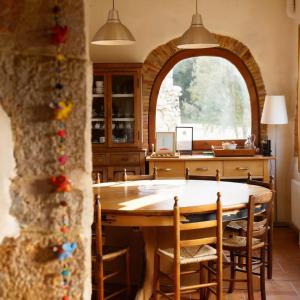 a kitchen with a large wooden table and chairs at La Casa de la Llum in Amer +46 photos