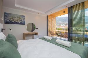 a bedroom with a large bed and a large window at Asfiya Loft Apartments in Kalkan +66 photos