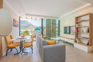 a living room with a table and chairs with a view at Asfiya Loft Apartments in Kalkan