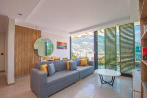 a living room with a couch and a table at Asfiya Loft Apartments in Kalkan
