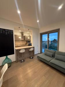 a living room with a couch and a large tv at Casa Clio in Noicattaro