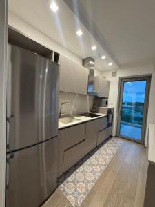 a kitchen with a stainless steel refrigerator and a window at Casa Clio in Noicattaro