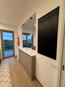 a kitchen with a large black screen on the wall at Casa Clio in Noicattaro