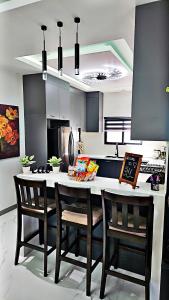 a kitchen with a table with chairs and a counter top at Villa Elegance-3 min Walk to the Beach-20 mins to Ochi Rios in Richmond