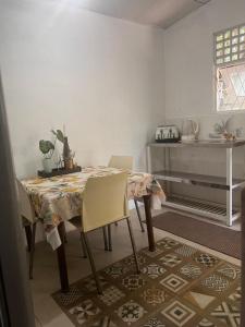 a dining room with a table and chairs in a room at Airport home stay in Ekala