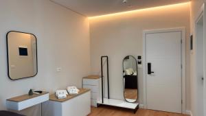 a bathroom with a sink and two mirrors at Hotel Metali - City Centre in Sarandë +113 photos