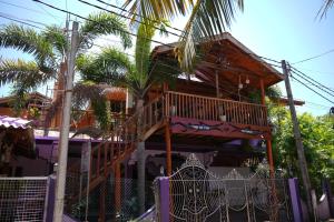 a house with a wooden staircase in front of it at SNP Star Guest House in Trincomalee