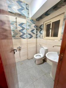 a bathroom with a toilet and a sink at Saray Hotel Dahab in Dahab