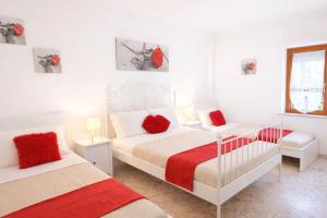 a white bedroom with two beds and a window at Casa Sant'Antonio in Bari +72 photos