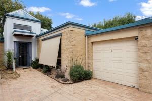 a house with two garage doors at Bay Breeze in Cowes
