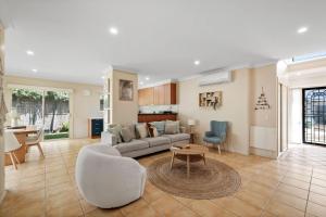 a living room with a couch and a table at Bay Breeze in Cowes