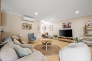 a living room with a couch and a tv at Bay Breeze in Cowes
