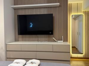 a living room with a tv on top of a dresser at Miraflores Alcanfores in Lima +8 photos
