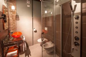 a bathroom with a shower and a toilet at Hotel Residence Diamantina in Ferrara