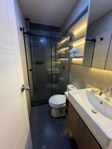 a bathroom with a shower and a toilet and a sink at Miraflores Alcanfores in Lima