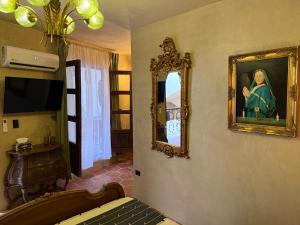 a room with a painting on the wall and a mirror at Riad Xula Boutique Hotel in Puerto Peñasco