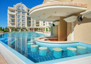 a swimming pool in front of a building at Rena Hotel - All Inclusive in Sunny Beach