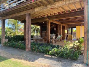 a wooden pergola with a table and chairs under it at Cabaña Olas del Viento 1 in San Bernardo del Viento +9 photos