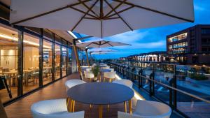 a balcony with tables and chairs on a building at InterContinental Yokohama Pier 8 by IHG in Yokohama