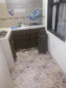 a kitchen with a sink and a counter top at Hospedaje Donde Jaime-Choachí in Choachí