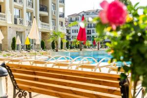 a row of tables and chairs next to a swimming pool at Rena Hotel - All Inclusive in Sunny Beach