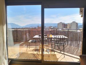 a patio with a table and chairs on a balcony at ACOGEDOR ÁTICO DÚPLEX EN TREMP in Tremp