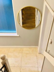 a bathroom with a mirror and a tile floor at The King's Imperial Suite in Drogheda +31 photos