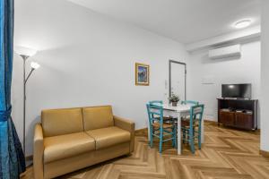 a living room with a couch and a table at Casa Diego, Colico Centro Living in Colico
