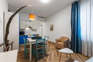 a kitchen and dining room with a table and chairs at Casa Diego, Colico Centro Living in Colico +70 photos