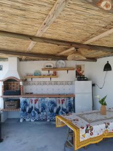 a dining room with a table and a wooden ceiling at Casa Picamilho in Porto de Mós