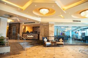 a lobby of a hotel with chairs and tables at Nile Trans Hotel in Cairo +82 photos