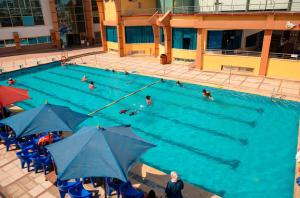 an overhead view of a swimming pool with people in it at Nile Trans Hotel in Cairo