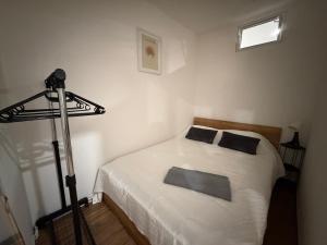 a bedroom with a white bed and a camera at ApartmentsByMatyrafa-XV in Tarnowskie Góry