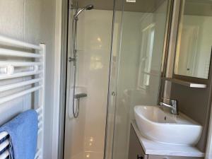 a bathroom with a shower and a sink at Sunseeker in Goedereede +20 photos