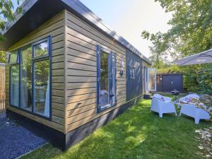 a tiny house with a table and chairs at Sunseeker in Goedereede