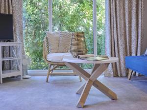 a living room with a chair and a table at Sunseeker in Goedereede