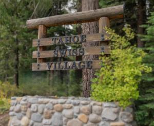 a sign that says tareperyss village in a forest at 1st Cabin in Homewood