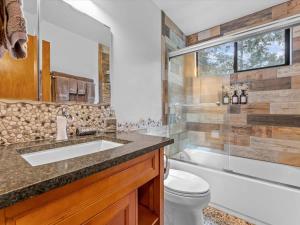 a bathroom with a sink and a tub and a toilet at 1st Cabin in Homewood