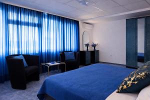 a hotel room with a bed and two chairs at Villa Andy -private yard, swimming pool, panoramic view in Imotski +24 photos