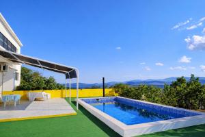 a swimming pool in the backyard of a house at Villa Andy -private yard, swimming pool, panoramic view in Imotski