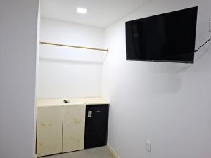 a room with a flat screen tv on the wall at Recanto de Boipeba in Ilha de Boipeba
