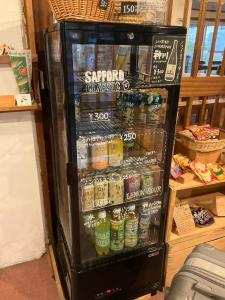 a refrigerator filled with lots of different types of drinks at Rishiri Greenhill Inn in Oshidomari