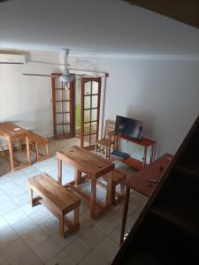 a living room with wooden tables and chairs at Bodegon in Encarnación +11 photos
