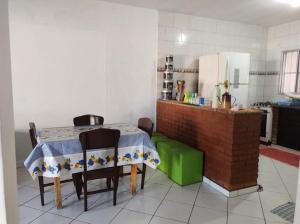 a kitchen with a table and chairs in a room at Casa Garcia in Ilha Comprida