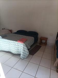a bedroom with a bed and a tiled floor at Bodegon in Encarnación