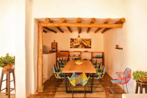 a dining room with a table and chairs at Romantic Colonial Charm Barichara w Jacuzzi in Barichara
